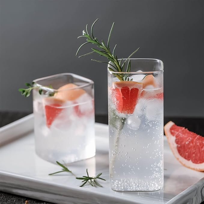 Elegant glass cups for water and juice. Square glass cups
