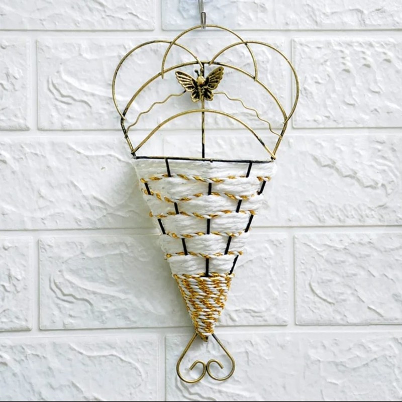 A metal vase with bamboo hanging on the wall