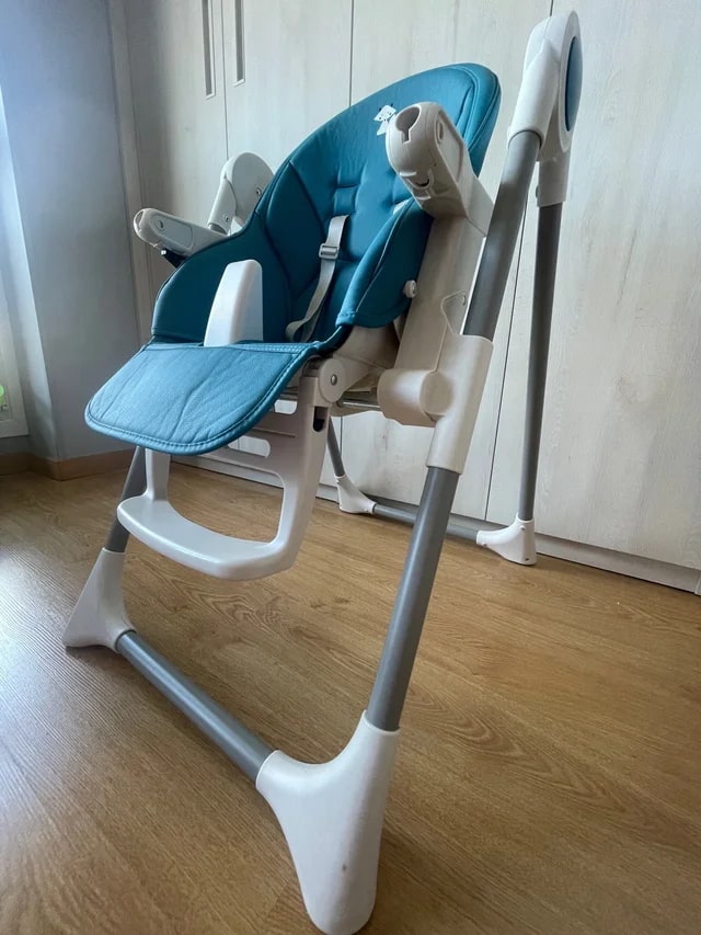Baby highchair with food tray on wheels in blue and white