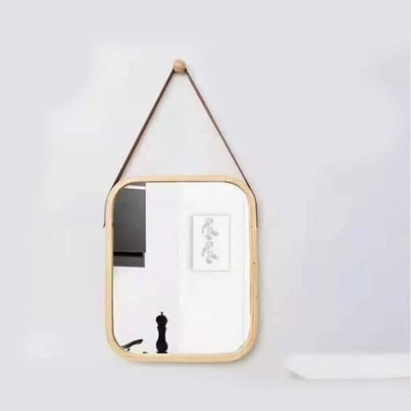 A wooden mirror and a leather pendant in a modern style