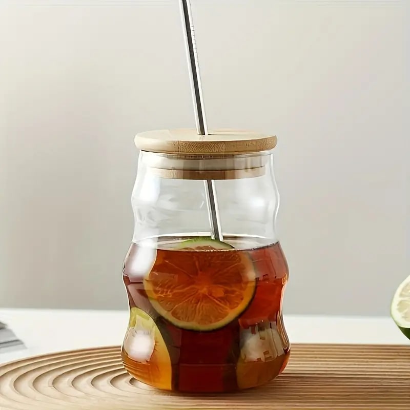 A Glass Cup for Cold Drinks with a Wooden Lid and a Glass Straw