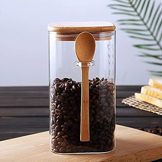 Airtight glass coffee jar with wooden spoon and wooden lid