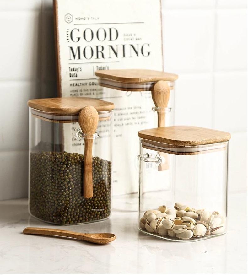 Airtight glass coffee jar with wooden spoon and wooden lid